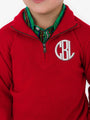 Red pullover with a monogram on a white background