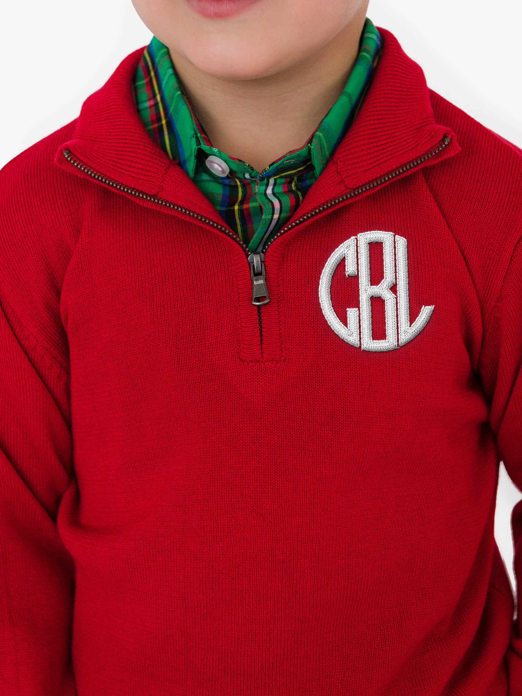 Red pullover with a monogram on a white background