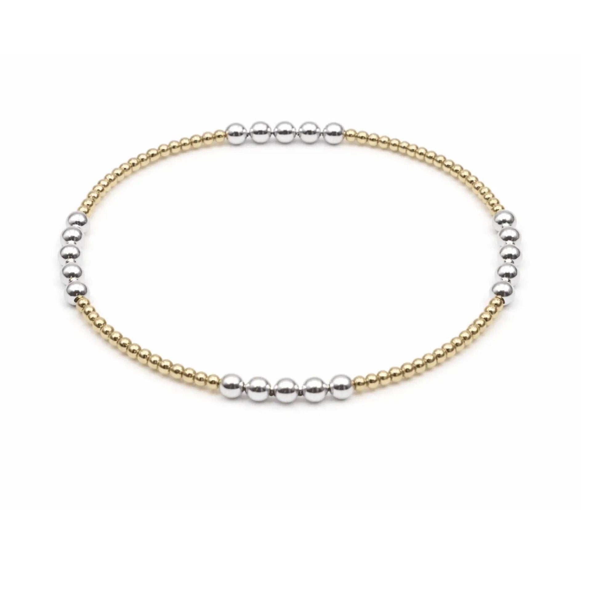 Two-toned gold and silver beaded bracelet on a white background