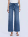 Person wearing blue jeans on a white background