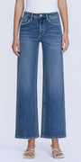 Person wearing blue jeans on a white background