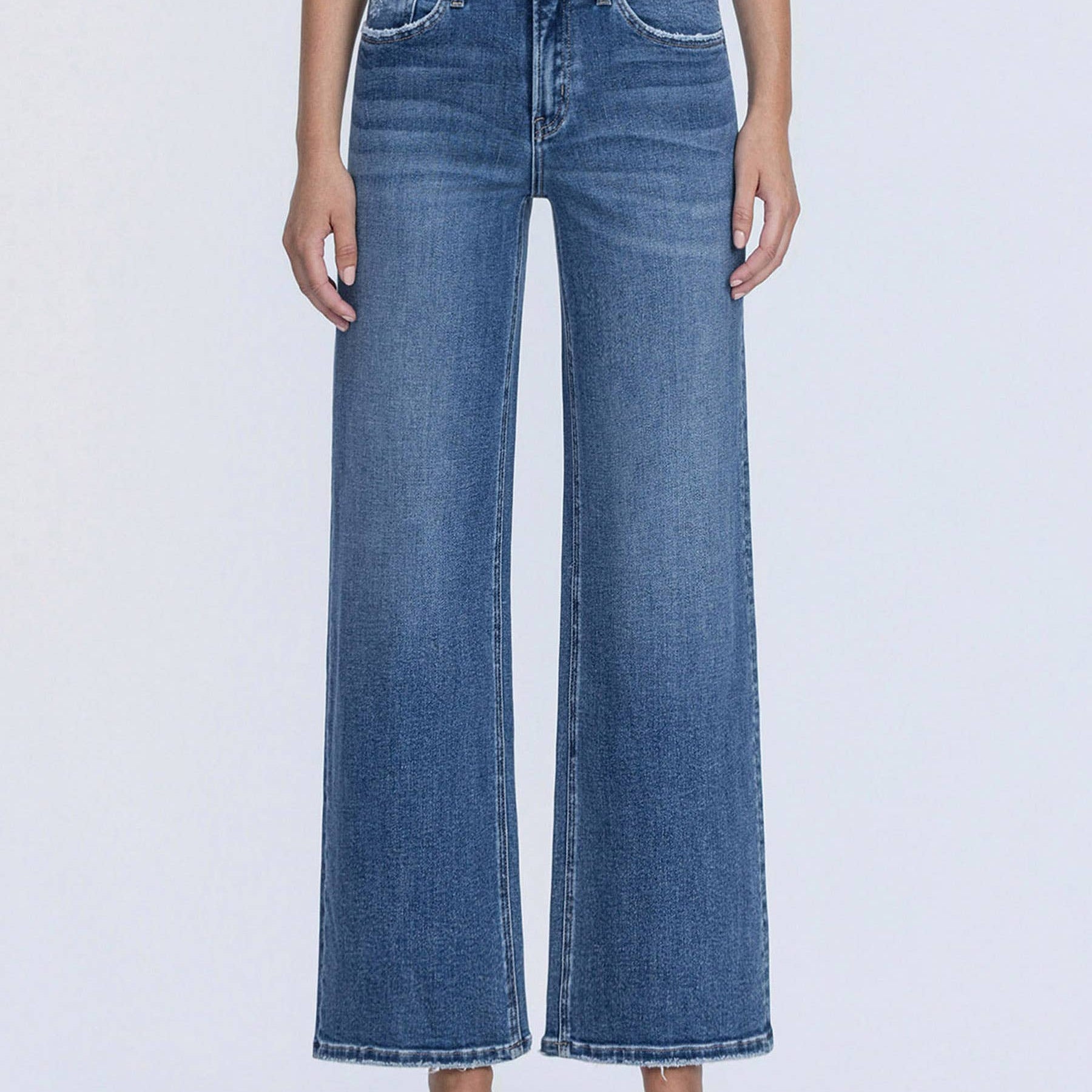 Person wearing blue jeans on a white background
