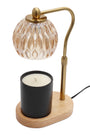 Candle warmer lamp with glass shade, brass arm, and black candle on a white background