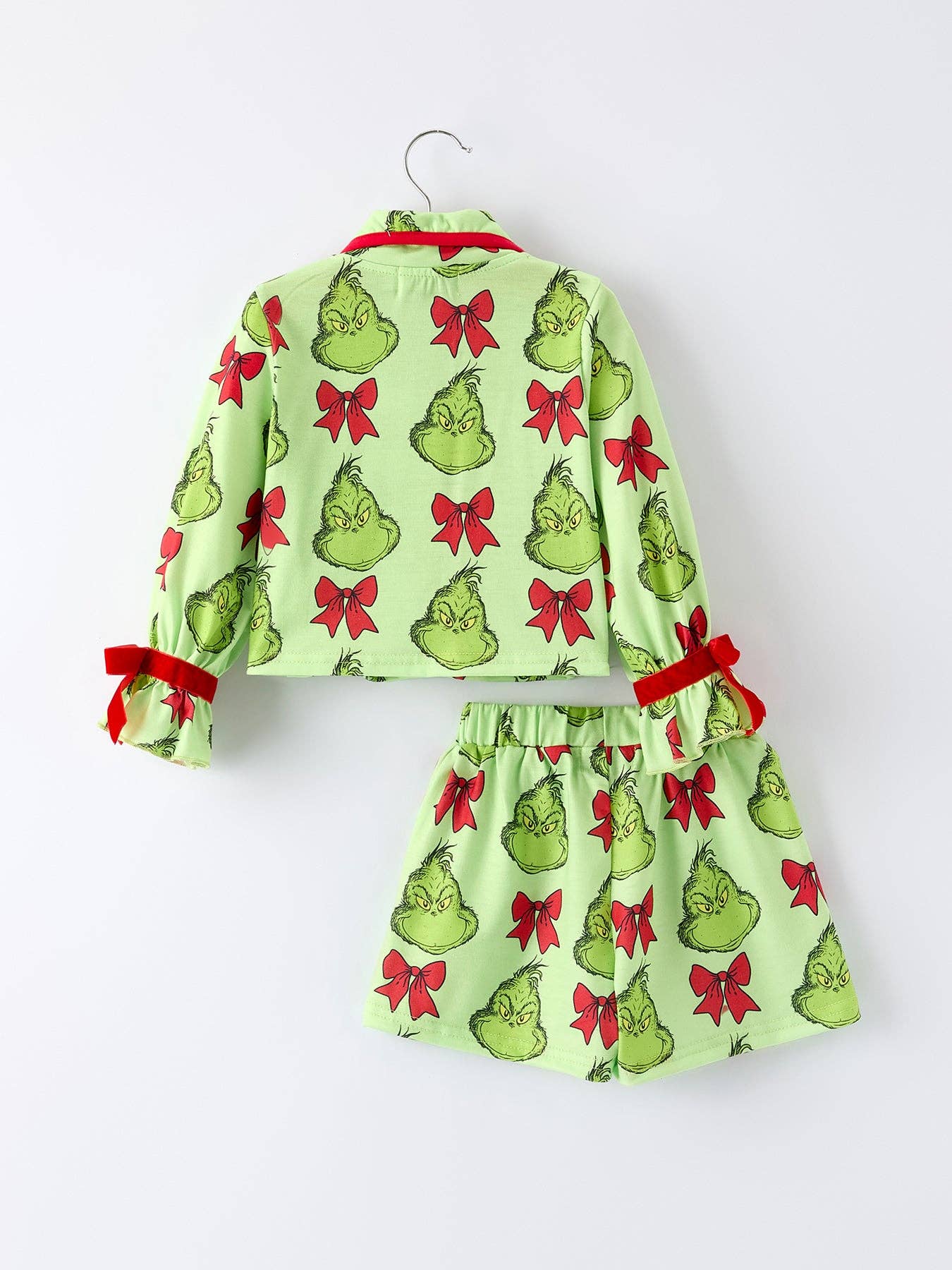 Children's outfit with Grinch pattern on a white background