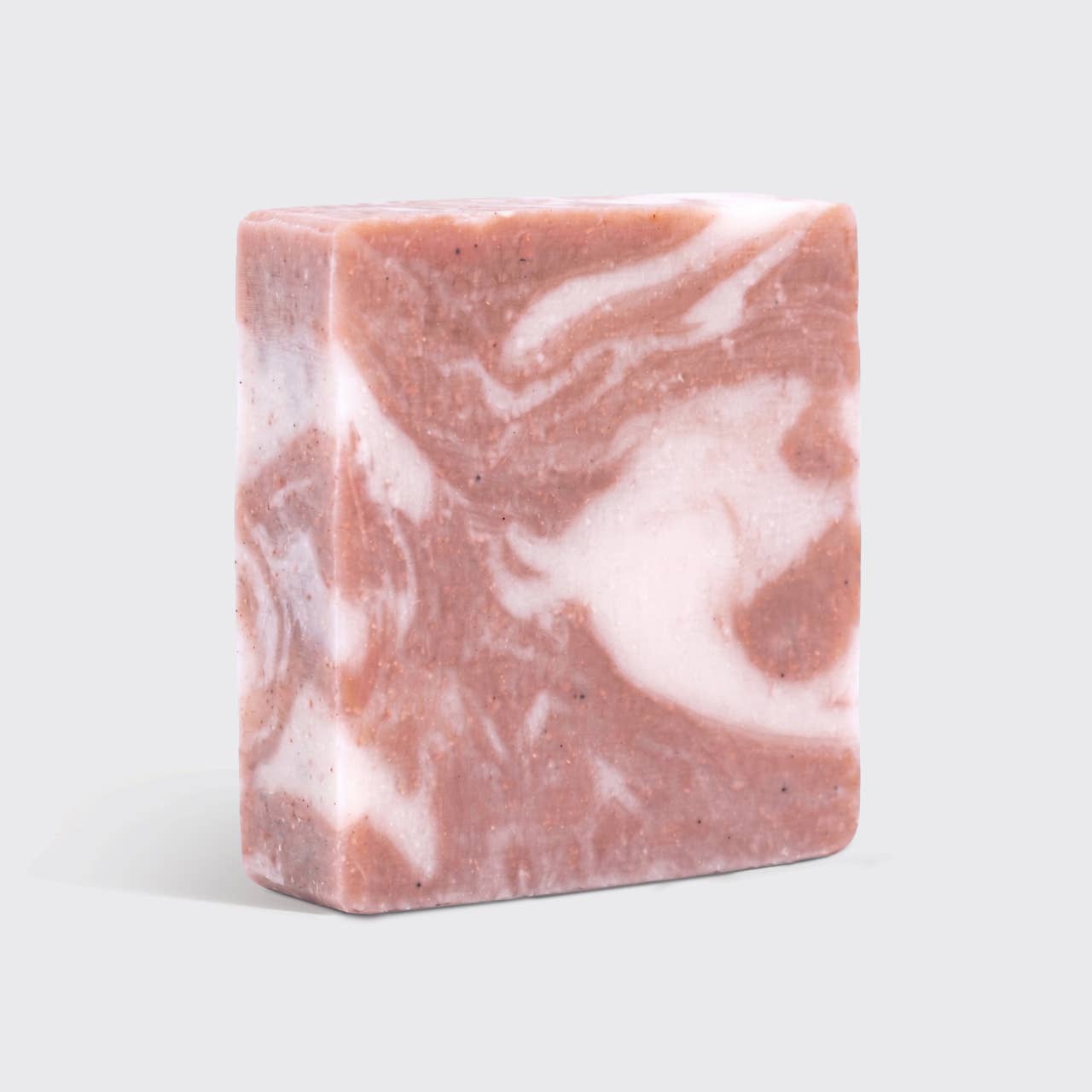 Marbled pink and white soap bar on a light gray background
