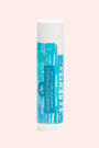 Lip balm tube with blue and white design on a light pink background