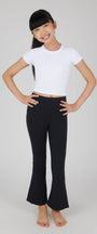 Person wearing a white crop top and black pants on a plain background