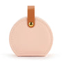 Round beige leather luggage tag with a brown strap and gold accent on a white background