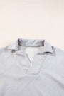 Light gray textured shirt on a light beige background