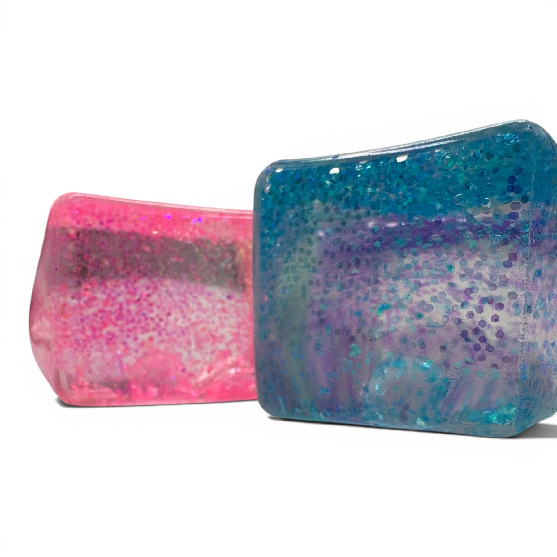 Two glittery rectangular objects, one pink and one blue, on a white background.
