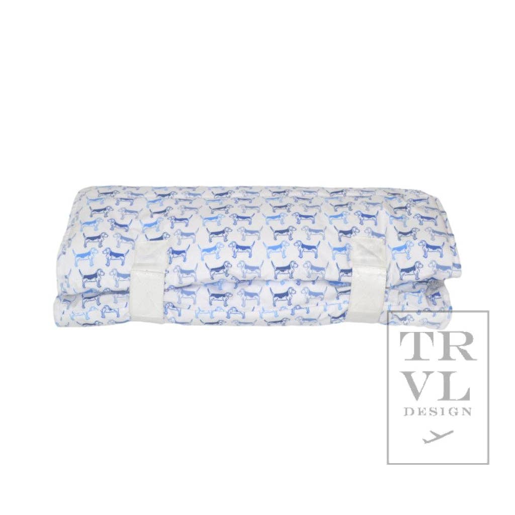 Folded fabric nap mat with blue dog pattern on a white background