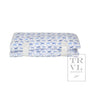 Folded fabric nap mat with blue dog pattern on a white background