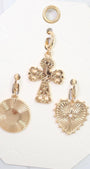 Gold cross and heart-shaped pendants on a white card