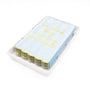 White ceramic towel tray holding stacked blue guest towels with gold script