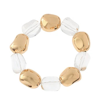 Bracelet with gold and clear beads on a white background