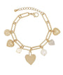 A gold-tone chain bracelet with multiple dangling charms, including heart-shaped pendants, a textured disc charm, a pearl bead, and a rhinestone-encrusted heart charm, shown on a plain white background.