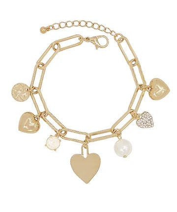 A gold-tone chain bracelet with multiple dangling charms, including heart-shaped pendants, a textured disc charm, a pearl bead, and a rhinestone-encrusted heart charm, shown on a plain white background.