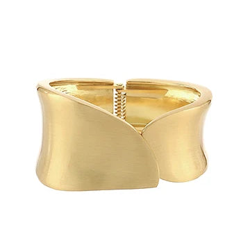 A wide, open cuff bracelet in polished yellow gold, featuring a sculptural, wavy, wing-like design with a textured spring clasp in the center, shown on a plain white background.