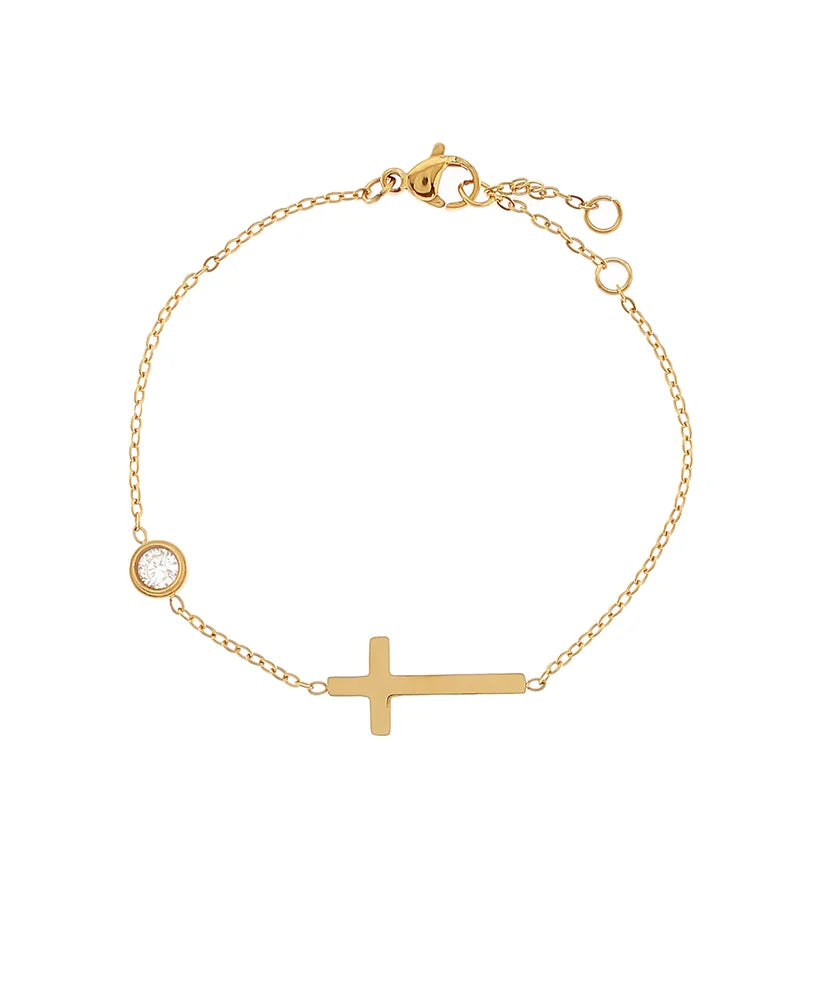 Gold bracelet with a cross and small round charm on a white background