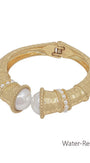 Gold bracelet with pearls on a white background