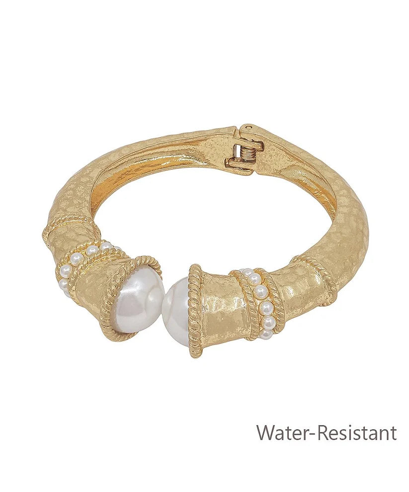 Gold bracelet with pearls on a white background
