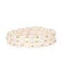 Set of pearl and gold beaded bracelets on a white background