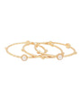 Three slim gold bangle bracelets with small bead details and round white pearl accents, arranged on a plain white background.