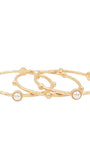 Three slim gold bangle bracelets with small bead details and round white pearl accents, arranged on a plain white background.