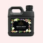 Jug of liquid with floral design on a black background
