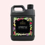 A bottle of laundry detergent with a decorative floral label on a white background