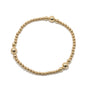 Gold beaded bracelet on a white background