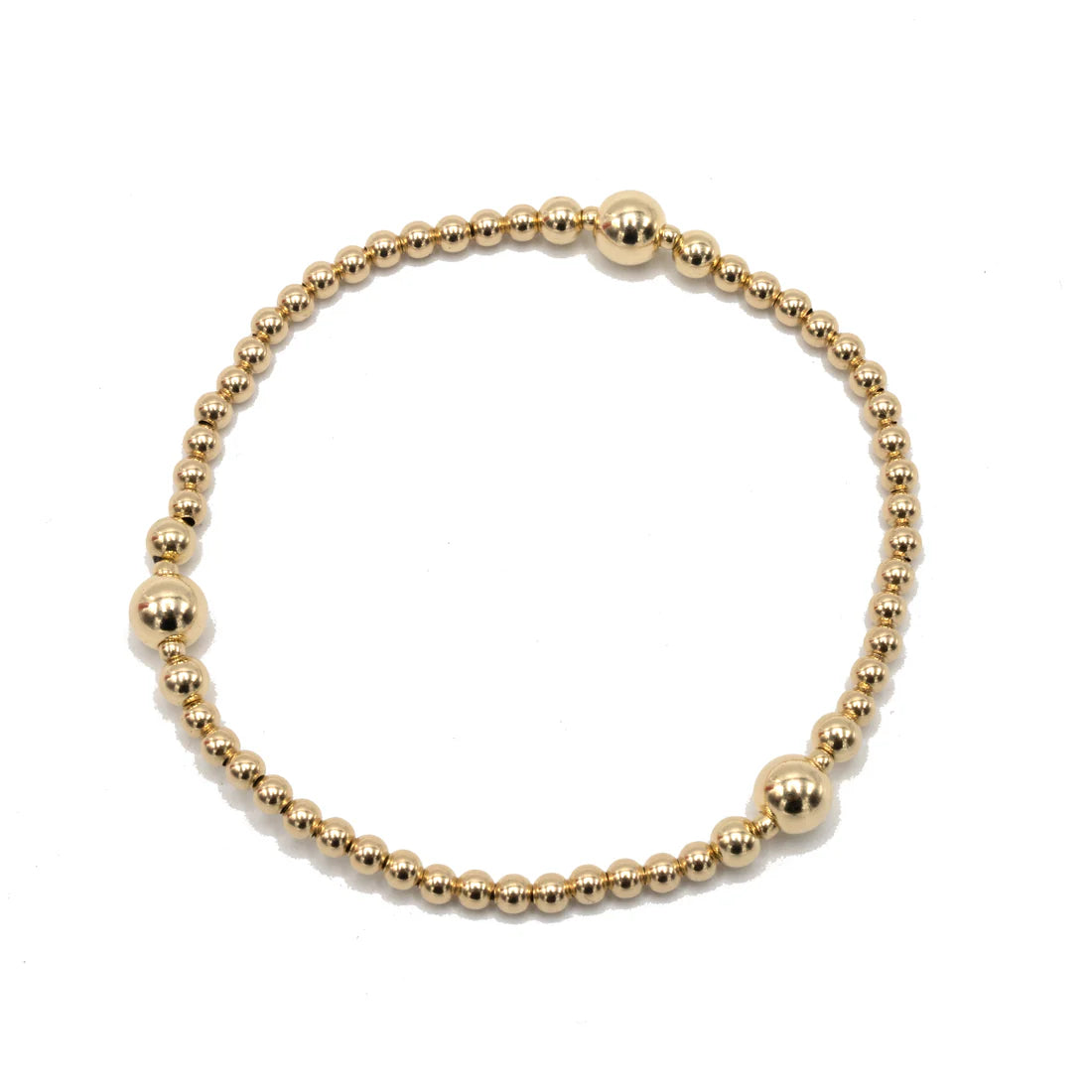 Gold beaded bracelet on a white background
