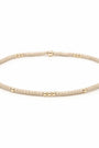 Gold beaded necklace on a white background