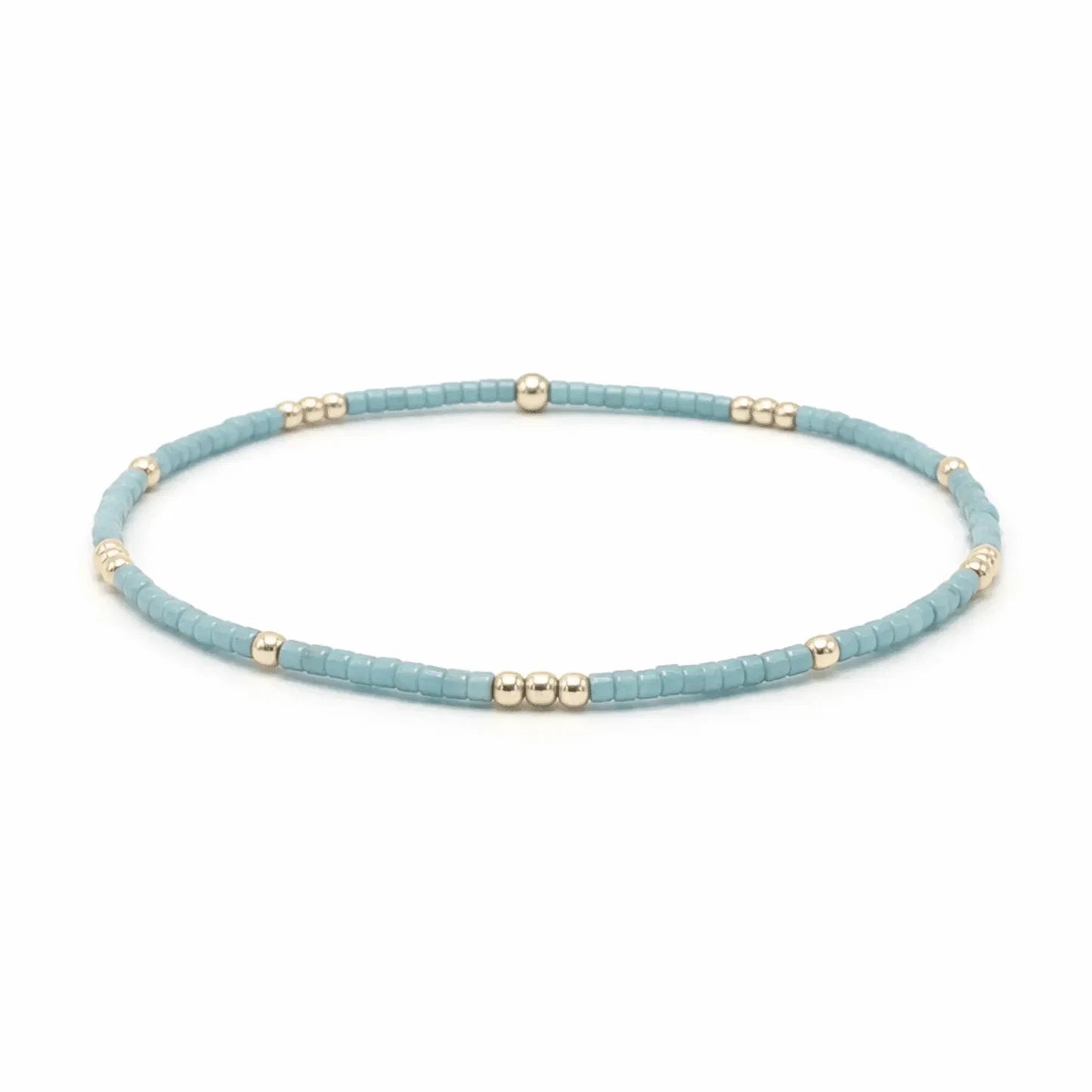 A beaded stretch bracelet featuring textured light blue beads separated by small metallic gold spacer beads, displayed on a clean white background.