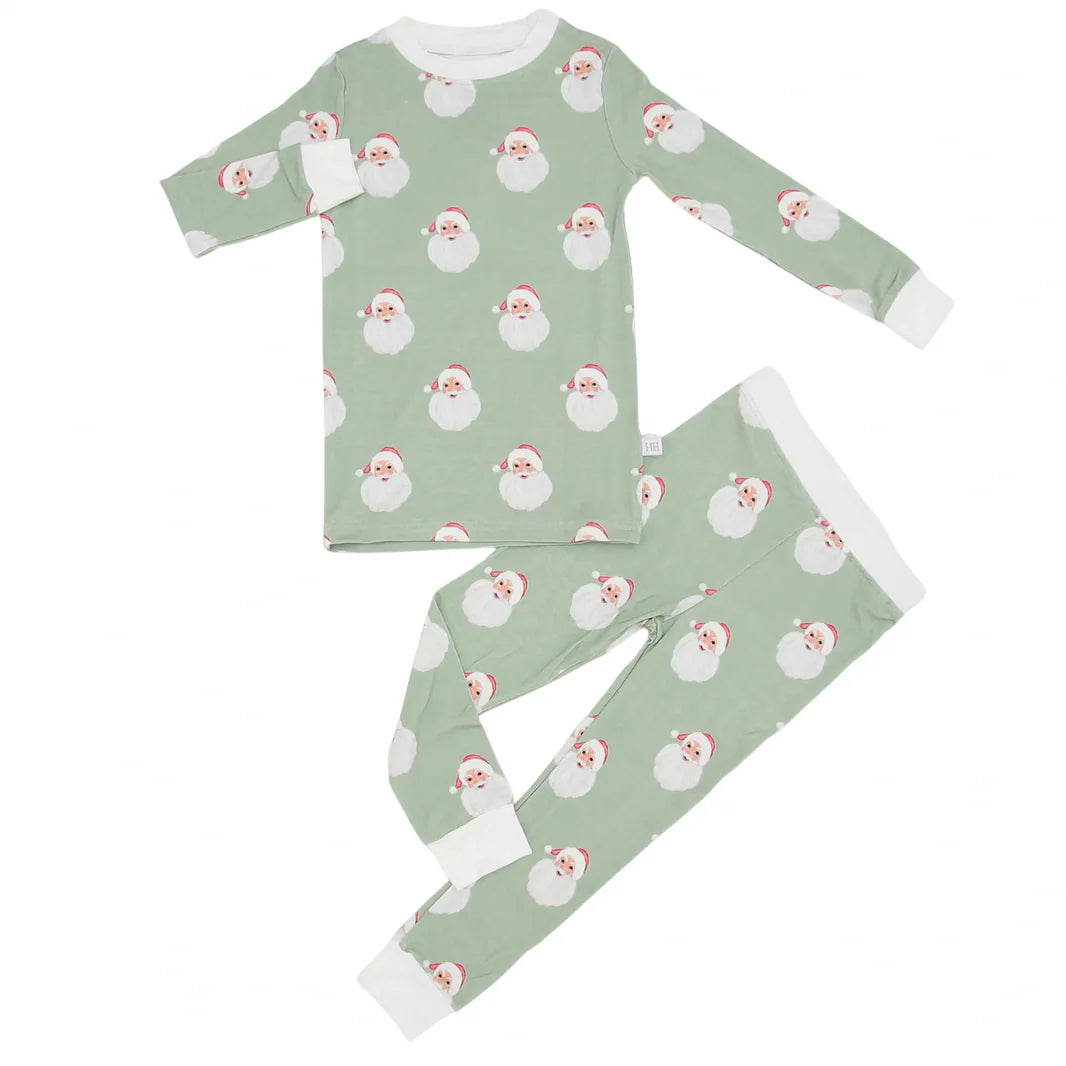 Children's pajama set with Santa Claus pattern on a green background