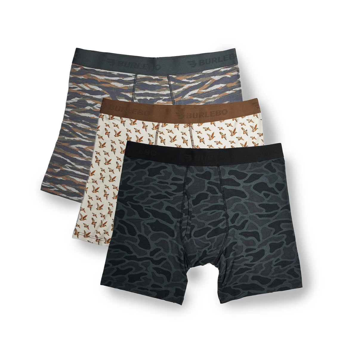 Three pairs of men's boxer briefs from Burlebo are displayed in a stacked arrangement on a white background. The front pair features a dark gray and black abstract camouflage pattern, the middle pair has a brown waistband and a beige print of small brown birds, and the back pair has a gray and brown tiger-stripe pattern.