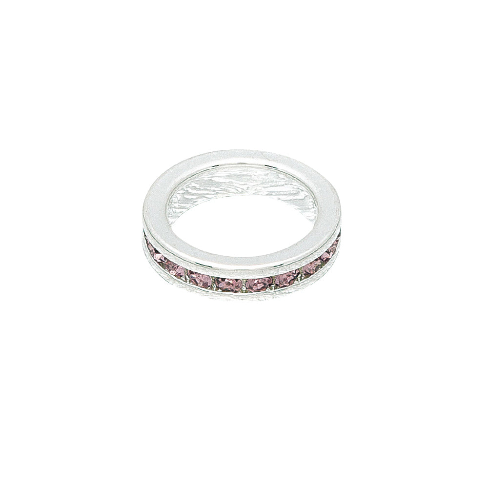 Silver ring with pink stones on a white background