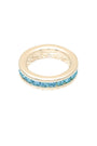 Gold ring with blue gemstones on a white background