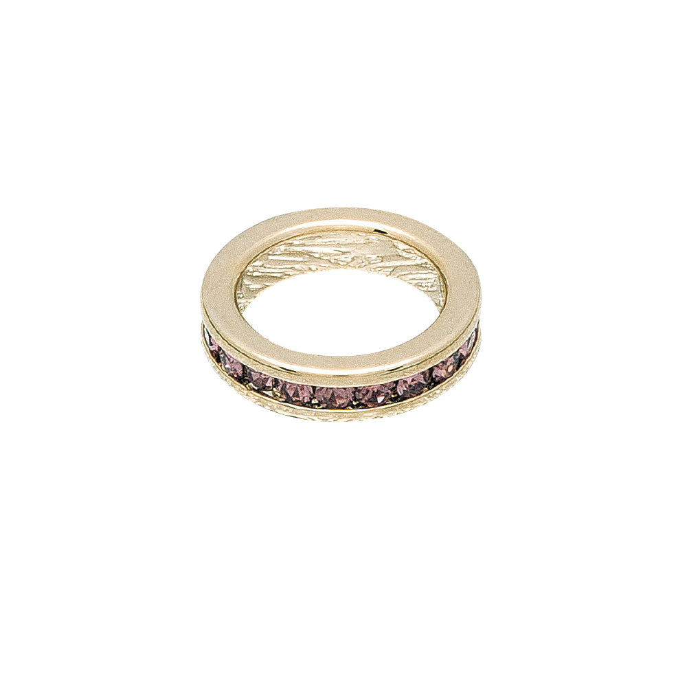 Gold ring with pink gemstones on a white background