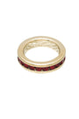 Gold ring with red gemstones on a white background