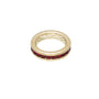 Gold ring with red gemstones on a white background