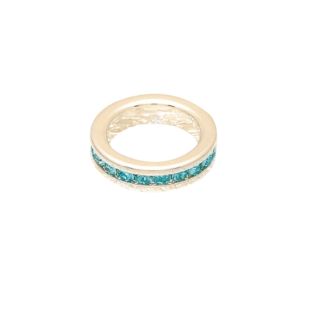 Gold ring with turquoise stones on a white background