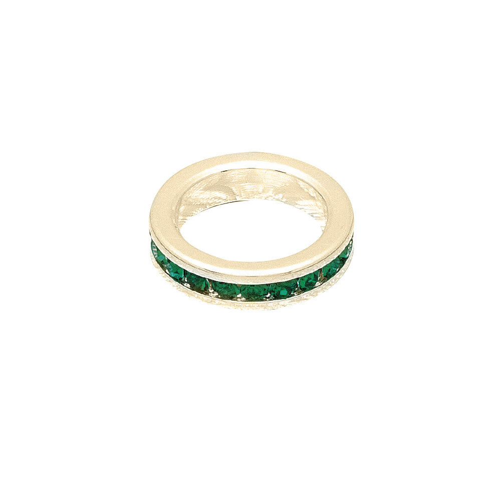 Gold ring with green gemstones on a white background
