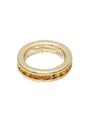 Gold ring with embedded stones on a white background