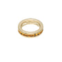 Gold ring with embedded stones on a white background