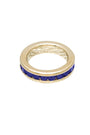 Gold ring with blue stones on a white background