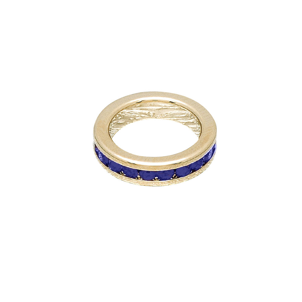 Gold ring with blue stones on a white background