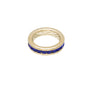 Gold ring with blue stones on a white background