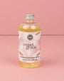 Bottle of 'sweet grace' flower diffuser refill on a pink background