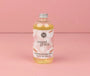 Bottle of 'sweet grace' flower diffuser refill on a pink background
